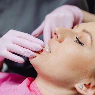 A woman receives dental care during a routine checkup, focusing on oral health.